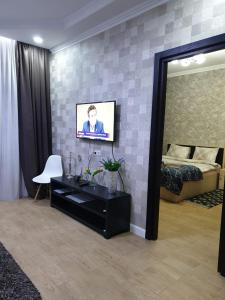 a living room with a tv and a mirror at Old Tbilisi Apartments1 in Tbilisi City