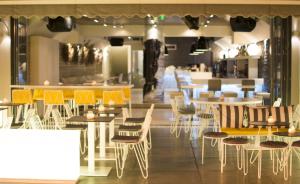 ein Restaurant mit Tischen und Stühlen und eine Cafeteria in der Unterkunft Bourtzi Hotel in Skiathos-Stadt