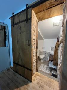 an open door to a bathroom with a toilet at DOMUS VELA in Fornelli +58 photos