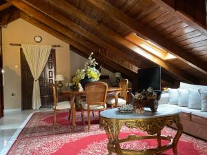 a living room with a table and a couch at Porfyra Luxury Guesthouse in Kalavrita