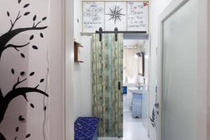 a hallway with a shower in a bathroom at Lodge&Art Hostel in Trieste