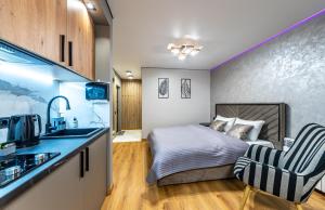 a small bedroom with a bed and a kitchen at MYFREEDOM Апартаменти пр-т Правди 6 in Kyiv