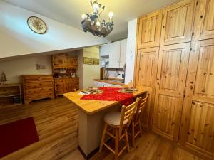 a kitchen with a table with a red table cloth on it at Liuby Home in Sestriere
