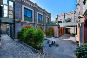 an empty courtyard in an apartment building with plants at Dongsi No 78 Boutique Apartment in Beijing