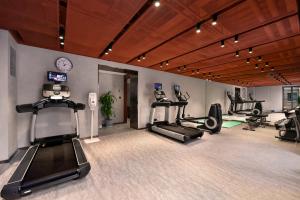 a gym with treadmills and ellipticals in a room at Dongsi No 78 Boutique Apartment in Beijing