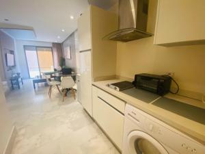 a kitchen with a washer and a kitchen with a microwave at Maarif in Casablanca