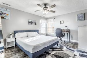 a bedroom with a bed and a desk and a chair at King Size Bed Bungalow with a Gym in Indianapolis in Indianapolis
