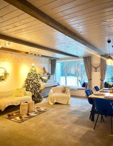 a living room with a christmas tree in the corner at Family house in Druskininkai
