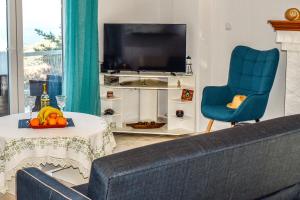 Телевизор и/или развлекательный центр в Nest View House