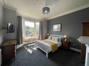 a bedroom with a bed and a table and a window at Serviced Apartment- 1 Bed-Next To Train Station in Sleightholme