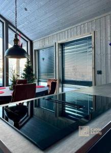 a glass table in a room with a dining room at New cabin near X Country ski trails at Blefjell with Jacuzzi in Flesberg