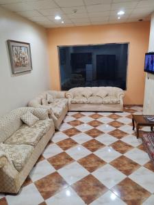 a living room with two couches and a television at منتجع الريحانه فله رقم 1 in Taif