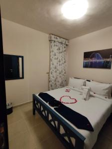 a bedroom with a bed with a black and white blanket at Porto Sharm-Elsheikh in Sharm El Sheikh