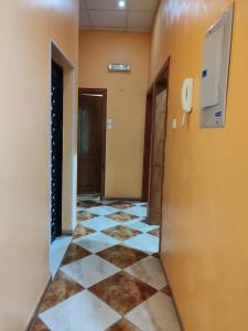 a hallway with a tile floor and a phone on a wall at منتجع الريحانه فله رقم 1 in Taif