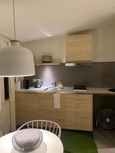 a kitchen with a table and a kitchen with a sink at LUZZ me - Casa de Angra in Angra do Heroísmo