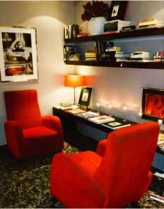 a room with two chairs and a desk and a lamp at Anba Boutique in Barcelona