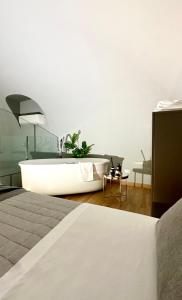 a bathroom with a bath tub in a room at Jacuzzi Luxury Apartment in the Town Centre in Turin