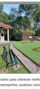 a park with two swings and a playground at Apto 2px.unesc in Criciúma
