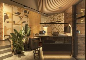 a coffee shop with a counter and a plant at FULL HOUSE apart hotel in Rivne