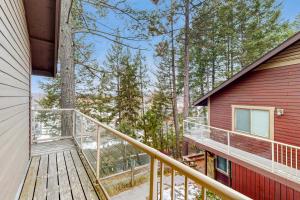 a balcony of a cabin with a red house at Bay Point Hillside 17A Up in Whitefish
