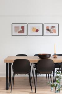 a dining room with a table and chairs at SPACIOUS Apartment in London