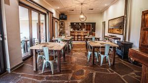 a dining room with wooden tables and chairs at Jonkershoek Guest Farm in Kimberley