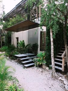 a house with stairs leading up to it at Invisible Loft Experience in Tulum