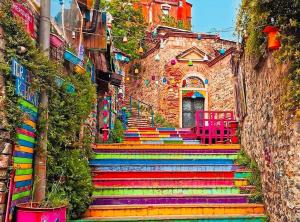 a group of colorful stairs with a building at Fener sweet in Istanbul