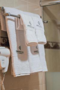 un grupo de toallas colgando de un estante en el baño en Casona Plaza Hotel Puno, en Puno