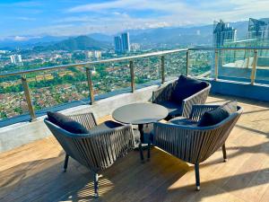 une table et des chaises sur un balcon avec vue dans l'établissement Couple Suite at Neu Suites near Gleneagles, à Kuala Lumpur