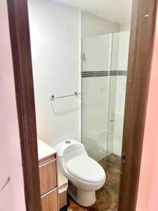 a bathroom with a toilet and a glass shower at Perfect 3BR Apartment Medellin best location in Medellín