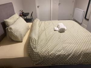 a white stuffed animal laying on a bed at A private room,A private bathroom in Dublin