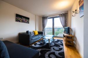 a living room with a couch and a tv at Beautiful and spacious 2-Bed Apartment in London in London