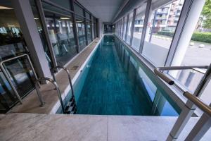 a swimming pool in a building with blue water at Beautiful and spacious 2-Bed Apartment in London in London
