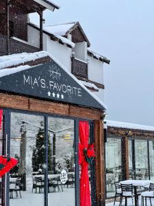 a store front with a red bow in the window at Mia's Favorite Hotel in Mavrovo