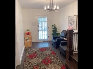 a living room with a couch and a chair and a rug at Beautiful bedroom next JHU in Baltimore