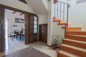 a hallway with stairs and a dining room with a table at Quinta do Rio Alva and Glamping Lodges in Mouronho
