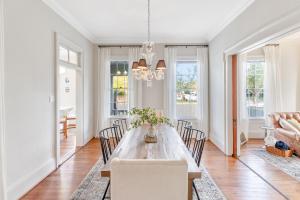 a dining room with a long table and chairs at Coastal Breeze Cottage with Private Pool in Galveston