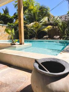 a swimming pool with a toilet in front of it at Nakupenda paje villa in Paje