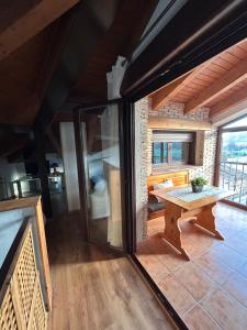 a room with a wooden table in a house at Tranquilo apartamento vistas al Mondalindo 