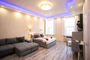 a living room with a bed and a couch at GrigorasNCo Studio Apartments in Budapest