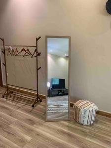 a mirror and a suitcase in a room at Brown vibes comfy studio in Jeddah