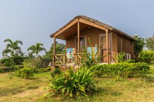 a small house with a grass roof at Leo Woods Hampi River view in Hampi