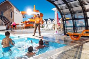 a woman is standing in a swimming pool at Comfortable apartments, swimming pool, Sarbinowo in Sarbinowo