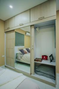 a bedroom with a bed and a large glass wall at Hidden Villa Aruba in Oranjestad