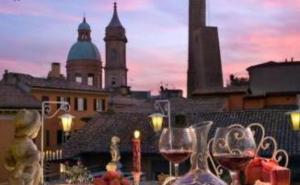 a view of a city with two glasses of wine at Hotel San Donato - Bologna centro in Bologna