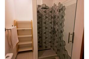 a shower with a glass door in a bathroom at Appartement à Monte Buena Vista in Las Terrenas