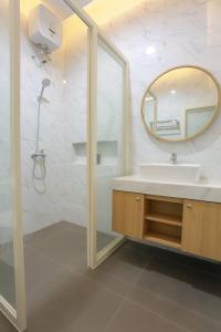 a bathroom with a sink and a mirror at The Horizontal Hotel Pacitan in Pacitan