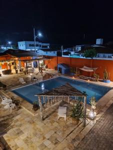 an outdoor swimming pool at night at Bed & Breakfast Casa de Valeria in Barra Nova