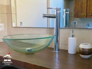 a glass bowl sink on a counter in a bathroom at APPARTAMENTO CREMONA FIERA in Cremona